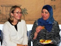 Two friends eating together - one western, one Arab
